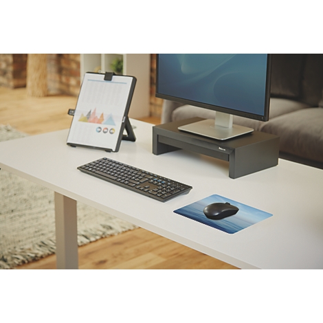 Hand op blauw patroon muismat met zwarte muis.