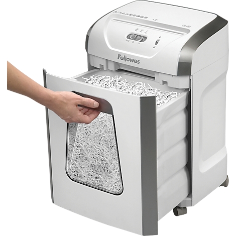 Person opening paper shredder drawer. The container is full of shredded paper. The device says "Fellowes".