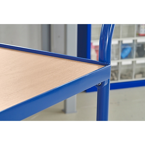 Close-up of part of a blue metal shelf with a wooden top. In the background, more shelves are visible.
