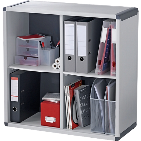 A white shelf with four compartments filled with binders, books, and office supplies.
