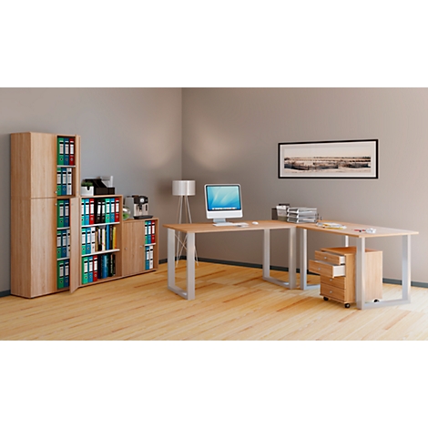 A modern office with a light wood desk, shelves and file cabinets. On the desk are a computer and office supplies.
