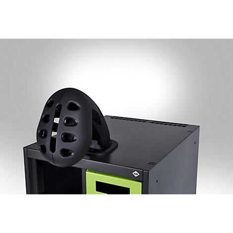 Black bicycle helmet on a black cabinet. Green accents. White background.