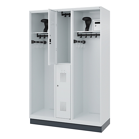White locker with three compartments, open compartment, and coat hooks. Helmets stored on top.