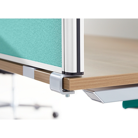Close-up of an office desk with a green partition and silver supports. The wooden table is held by a silver bracket.