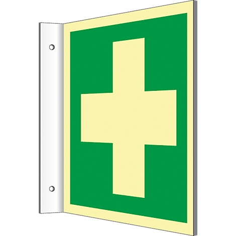 Emergency exit sign with green cross on yellow background. Mounted on white wall.