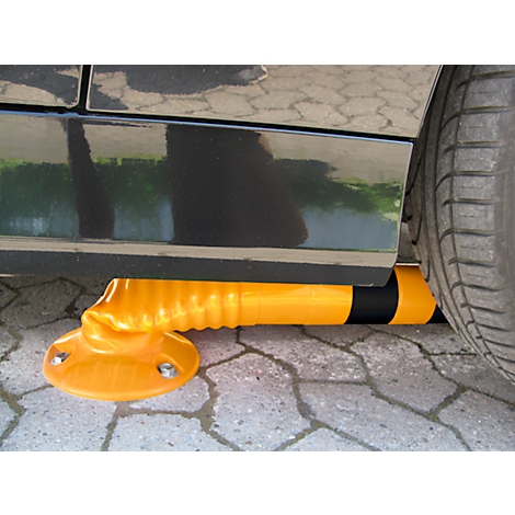 Yellow parking protection under black car, view of wheel and side of vehicle. The protection is deformed, the tire touches it.