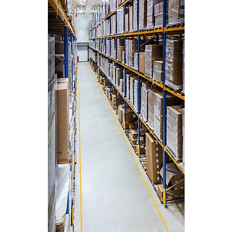 Warehouse interior with shelves stacked with packages and goods. Yellow line on the floor marks an aisle.