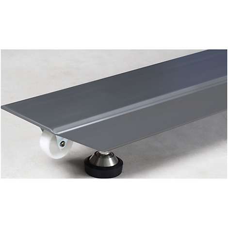 Gray metal plate on wheels and a black rubber foot. The plate is slightly angled.