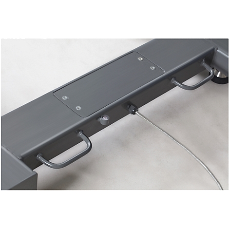 Close-up of a grey metal part. Handles, screws and a cable are visible.