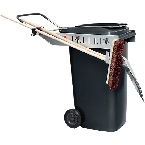 Black trash can with broom, snow shovel and poles. A bracket is attached to the top of the bin.