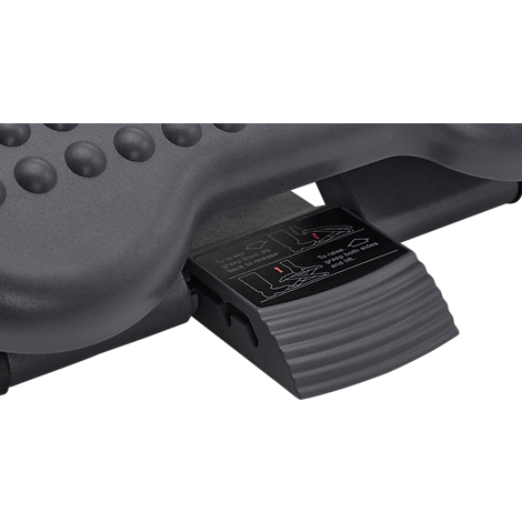Close-up of a black footrest mechanism. Instructions are pictured on a panel.