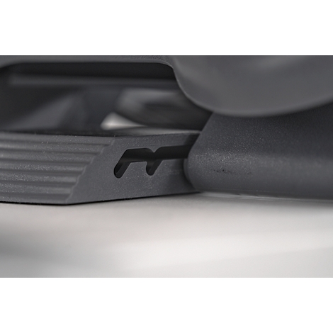 Close-up of a black plastic part with two recesses.