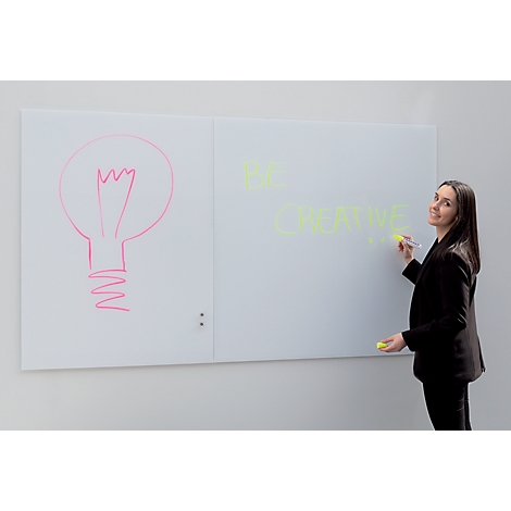 A woman writes "BE CREATIVE" on a white board with a yellow pen. A red light bulb is drawn on the board.