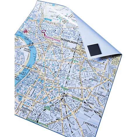 Düsseldorf city map, partially folded up, showing streets, buildings and sights. A magnet holds it in place.