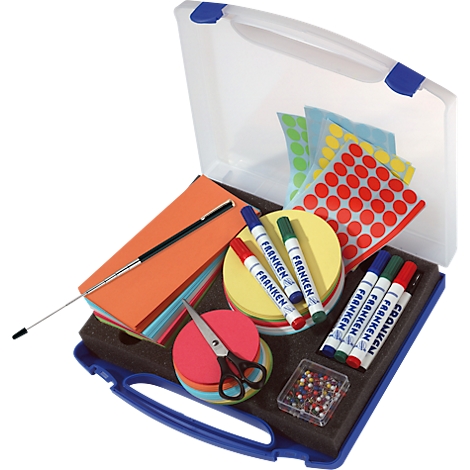 Open blue box with office supplies: markers, scissors, paper, sticky dots. Text on markers says 'FRANKEN'.