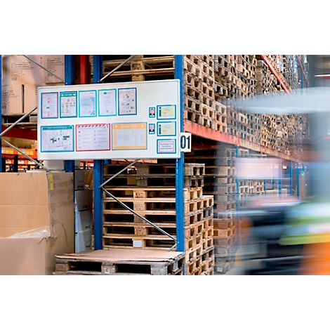 Overview board in warehouse, with documents and pallets in the background.
