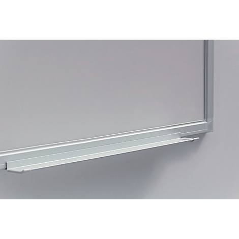 Close-up of a white board with an aluminum frame and storage tray. The board is slightly lit.