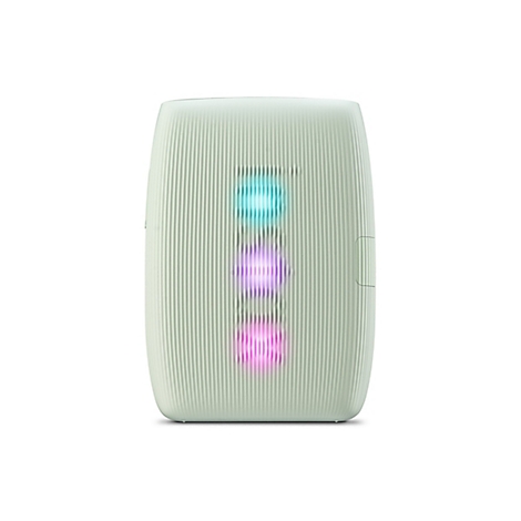 Ein hellgrünes, längliches Gerät mit geriffelter Oberfläche und drei leuchtenden Kreisen: blau, pink und pink.