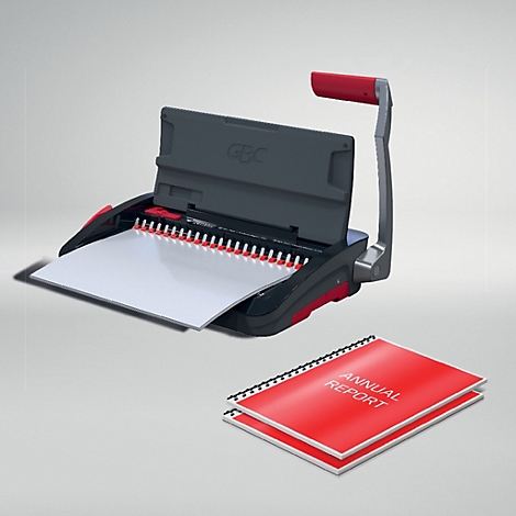 Een grijze bindmachine met rode handgreep, daarnaast een rood jaarverslag.