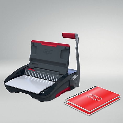 Een bindmachine met rode handgreep en een rood jaarverslagboek.