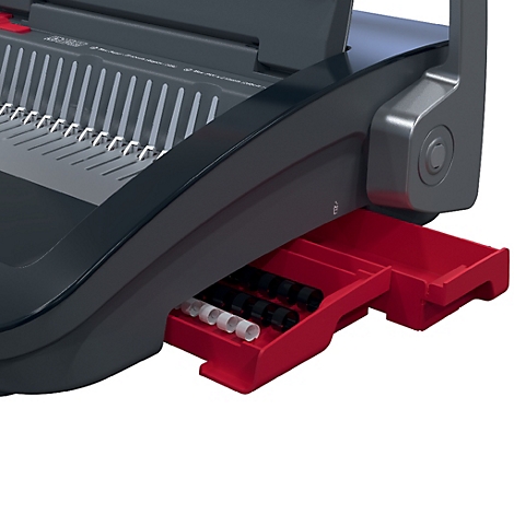 Detailaufnahme eines schwarzen und grauen Bindegeräts mit roter Schublade. In der Schublade liegen schwarze und weiße Binderinge.