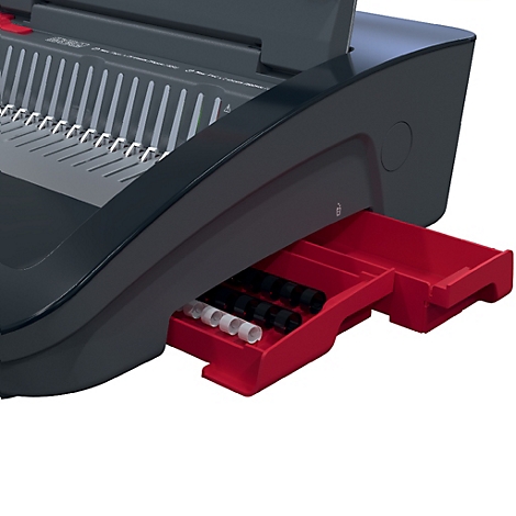 Detailaufnahme einer schwarzen Bindemaschine mit roter Schublade. In der Schublade sind Spiralbindungen in Schwarz und Weiß sichtbar.