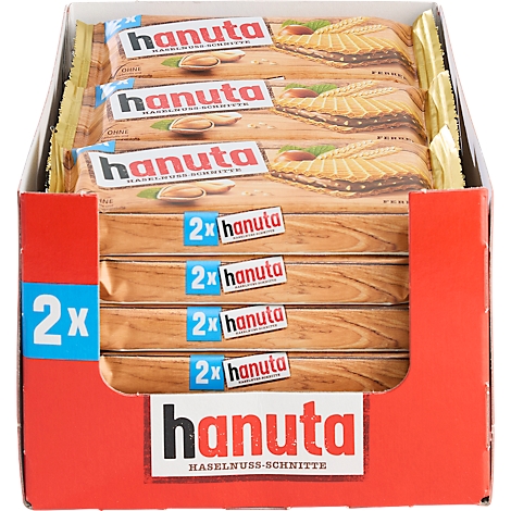 Display box filled with multiple Hanuta hazelnut wafer packs in a red cardboard box.