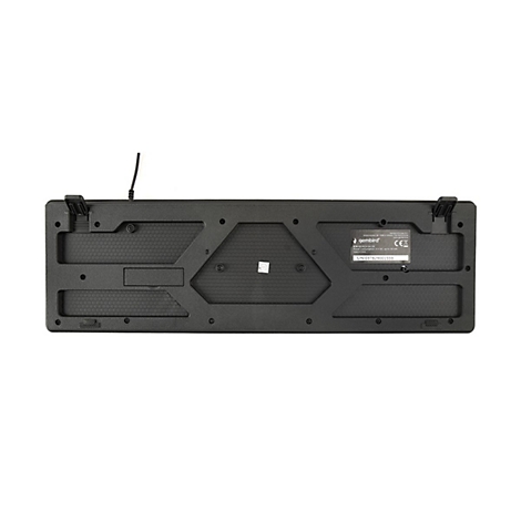 Rückseite einer schwarzen Tastatur mit Typenschild, ausklappbaren Standfüßen und wabenförmigem Gehäusedesign.