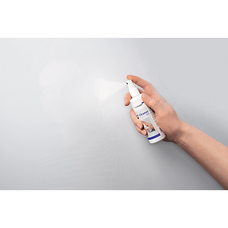 Hand spraying cleaner on grey surface. "t-cleaner" is written on the bottle.