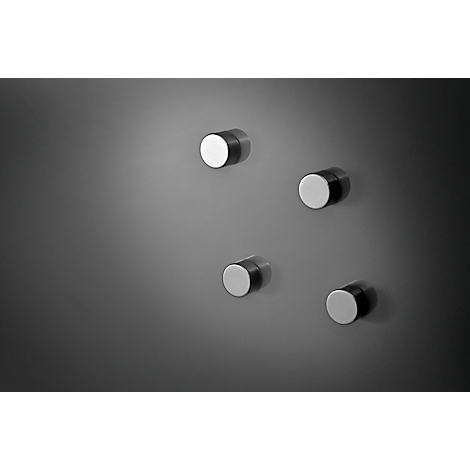 Four cylindrical magnets, two silver surfaces, dark background.