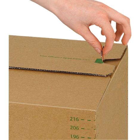 A hand opens a cardboard box. The box has green markings and lettering.