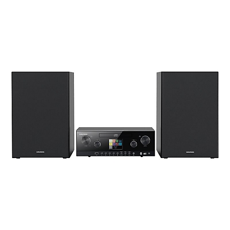 Schwarze Grundig Musikanlage mit zwei Lautsprechern und zentraler Steuereinheit mit Display vor weißem Hintergrund.