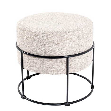 Ronde kruk met beige zitting en zwart metalen frame, kamerplant en raam op de achtergrond.