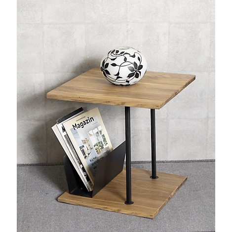 Houten tafel met zwart frame, een tijdschrift en een bal met bloemenpatroon.