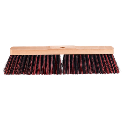 Broom with wooden handle, red and black bristles. Focus on bristles and handle.