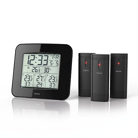 Schwarze Wetterstation mit Digitalanzeige und drei kleinen Sendern. Die Anzeige zeigt Uhrzeit, Datum und Temperatur.