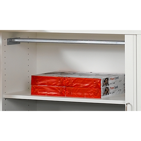 A white closet with two packs of paper. Above a clothes rail.