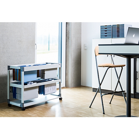 Mobile white file cabinet with drawers. In the corner a table with laptop and chair.