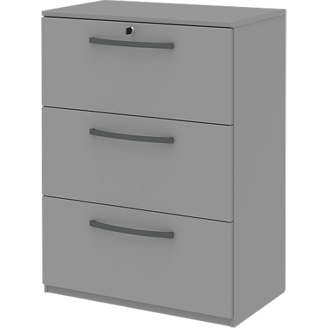 Gray filing cabinet with three drawers. Each drawer has a curved handle. The cabinet has a lock.