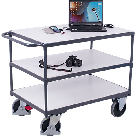 Three-tier service cart with gray frame, white shelves, and wheels, holding a laptop, camera, and phone.