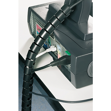Black cable spiral organizing computer and power cables, attached to a PC.