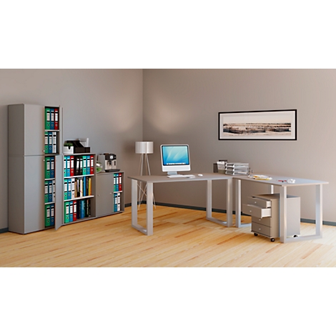 Office with desk, filing cabinets and computer. A framed picture hangs on the wall. The floor is wood.