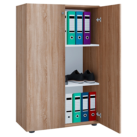 An open cabinet with wood grain. Shelves with binders and shoes. The door is open.