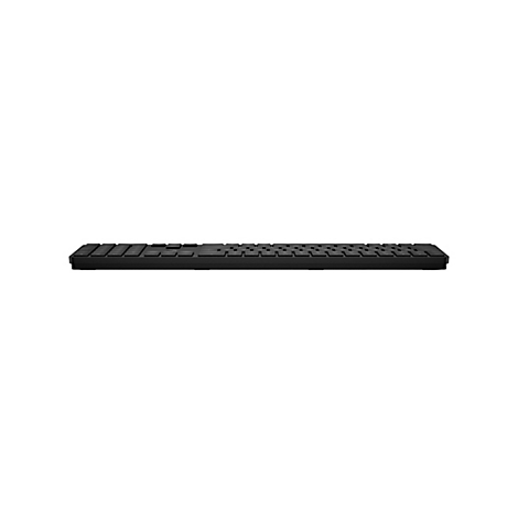 Schwarze, flache Computer-Tastatur in der Seitenansicht vor weißem Hintergrund.