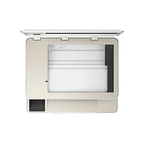 Vue de dessus d'un scanner à plat beige ouvert. Le couvercle est soulevé, montrant l'intérieur de l'appareil avec une feuille de papier.