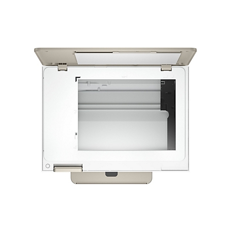 Vue de dessus d'un scanner ouvert en beige et blanc. Le bac à papier est visible, avec des spécifications de format en dessous.
