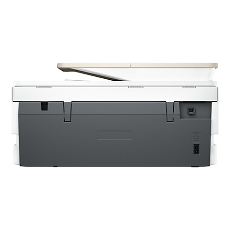 Vue arrière d'une imprimante, principalement blanche et grise, avec des connexions pour l'alimentation et l'USB.