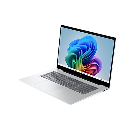 Ein silberner Laptop mit geöffnetem Bildschirm, auf dem ein farbenfrohes abstraktes Design zu sehen ist. Auf der Tastatur sind Buchstaben und Zahlen erkennbar.