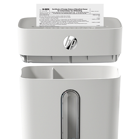 White paper shredder with HP logo, paper being shredded. The compartment below is visible for shredded paper.