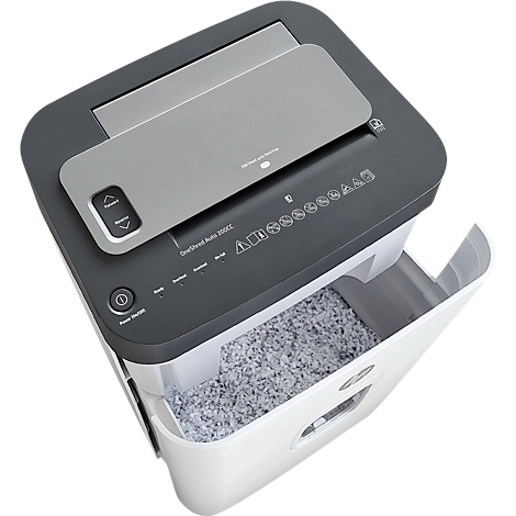 Shredder, gray and white, with open container. Control panel with arrows, shredded paper below.